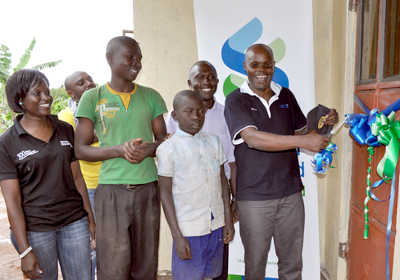 Stanchart's MD Kasekende officiating at the official handover of the house to the needy brothers