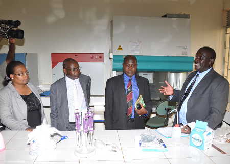 MUK Don Okello (right) conducts a tour of the newly refurbished lab at the university farm