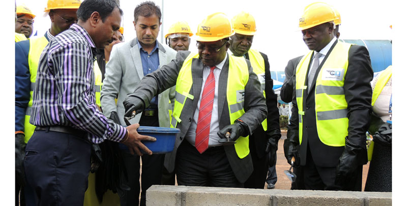 Works minister Eng. John Byabagambi (centre) lays a brick on the foundation of the airport's terminal expansion building as Civil Aviation Authority (CAA) board members look on during the site handover ceremony at Entebbe Airport