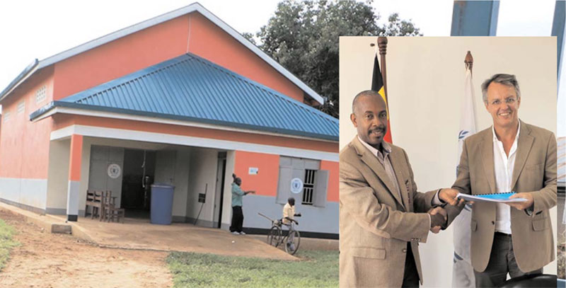 A grain store built by WFP in Iganga (Inste) is Samuel Mugasi (L) and Michael Dunford after signing the agreement