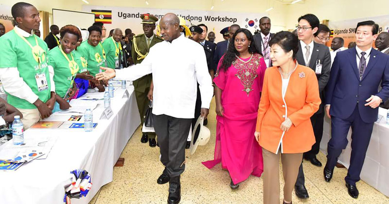 President Park (in Orange jacket) touring National Farmers Leadership Centre at Kampiringisa built by her government