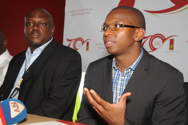 Uganda Breweries Out - going Managing Director, Nyimpini Mabunda (Right) addressing the press at Uganda Breweries. Looking on is in - coming MD, Mark Ocitti.