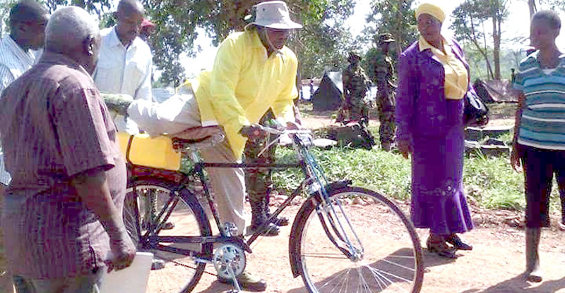 President Museveni mounting a bicycle in Luwero