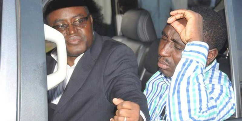 Omusinga wa Rwenzululu Mumbere (in glasses) appears unmoved when he was re-arrested, as opposed to his brother Kibazanga who appeared terribly annoyed by the Police's actions