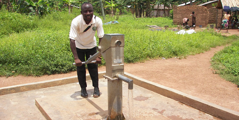 A man fetching water from a borehole