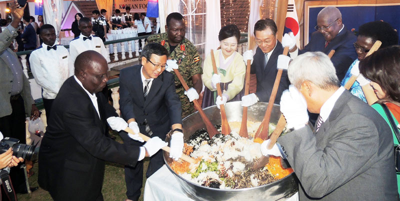 Foreign Affairs Minister Sam Kuteesa and his host Ambassador Park Jong Dae with other guests 