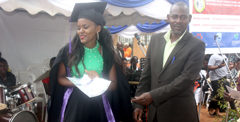 The pastor handing over a certificate to one of the graduands