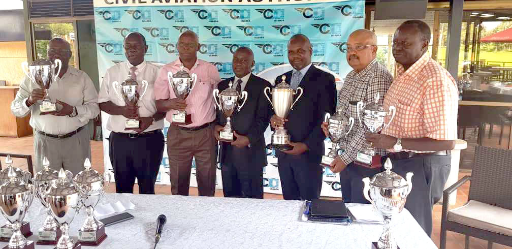 CAA's Manager Marketing and Commercial Services, Dr. Tom Davis Wasswa (centre) with Manager Public Affairs, Vianney Luggya (third right) and members of the executive of the Uganda Seniors Golfing Society while unveiling CAA's sponsorship package for the Seniors Golf Open fhatbrun from December 1-2 as part of the Aviation Week celebrations.