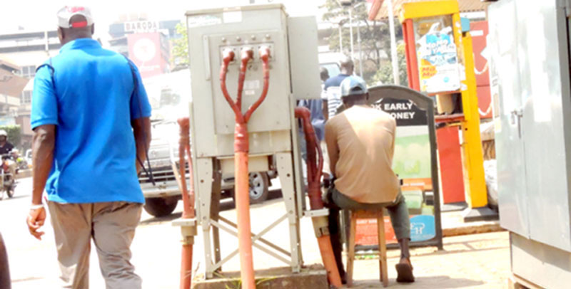 A man sits comfortably next to a transformer oblivious of the repurcussions of such an action