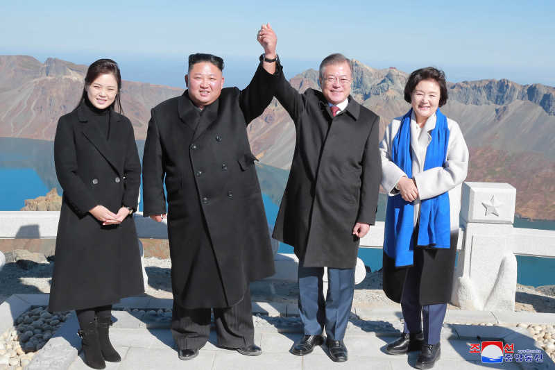 Supreme Leader Kim Jong Un and his wife Ri Sol Ju having a photo taken with South Korean President Moon Jae In and his wife Kim Jung Sook in memory of the historic moment of being on the top of Mt Paektu together, September, Juche 107 (2018)