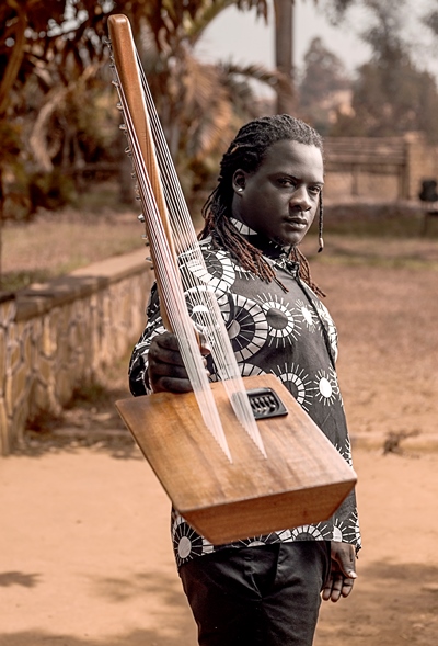 James Ssewakiryanga with his double scale string instrument