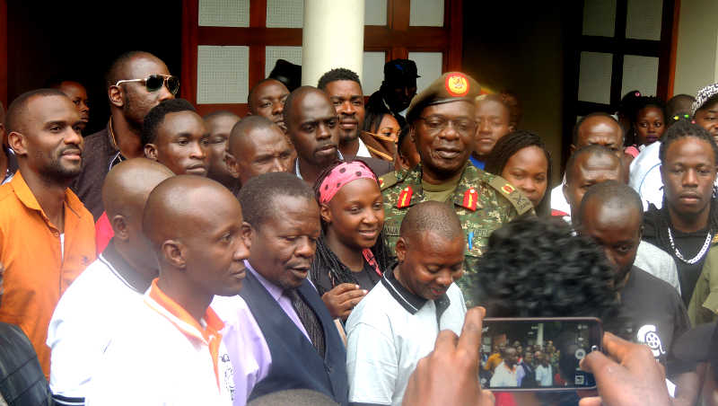 Maj. Gen. Kayanja with artists at the National Theater on Wednesday Morning where they launched a campaign against Piracy