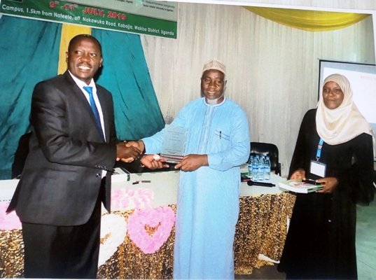 Associate Professor Mouhama Mpezamihigo, the Vice Chancellor of KIU receiving a gift from IUIU rector Ahmed Ssengendo