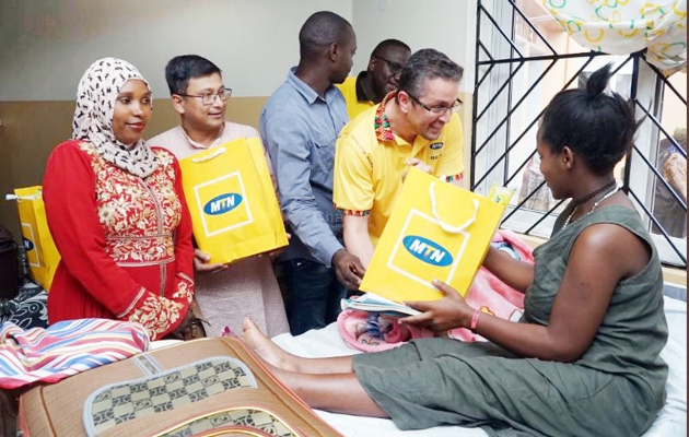 MTN officials visting a mother in hospital sometime back