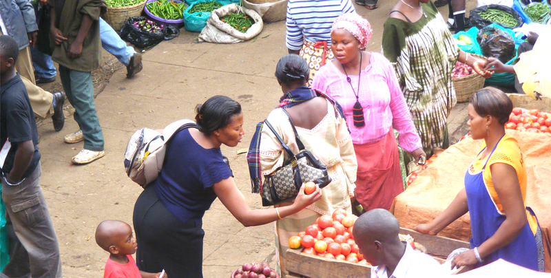 A woman buying tomatoes in market
