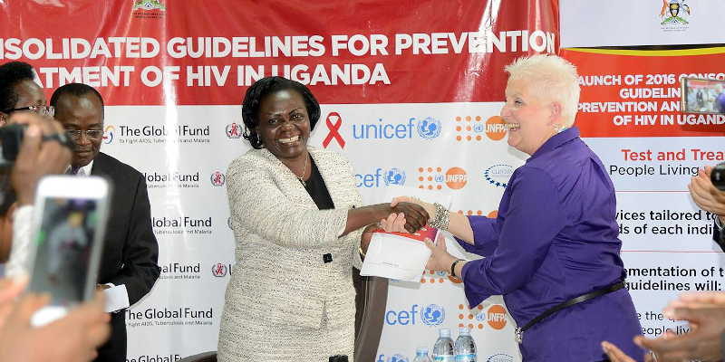 Health State Minister Sarah Ochieng shakes hands with Ambassador Malac at the launch of the new Test and Treat guidelines in Kampala