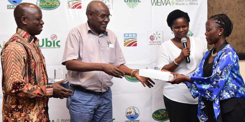 Mr. Lutaaya, receiving his award from Dr. Okasai Opolot, the commissioner for crop production ministry of Agriculture.